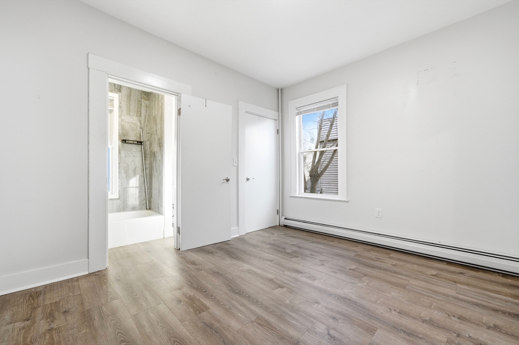 14-16 Ripley Street Malden, MA 02148 - Photo 11 of 37 a view of an empty room with wooden floor and a window