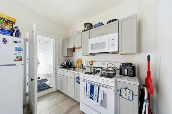 a kitchen with stainless steel appliances granite countertop a refrigerator a stove a sink and dishwasher