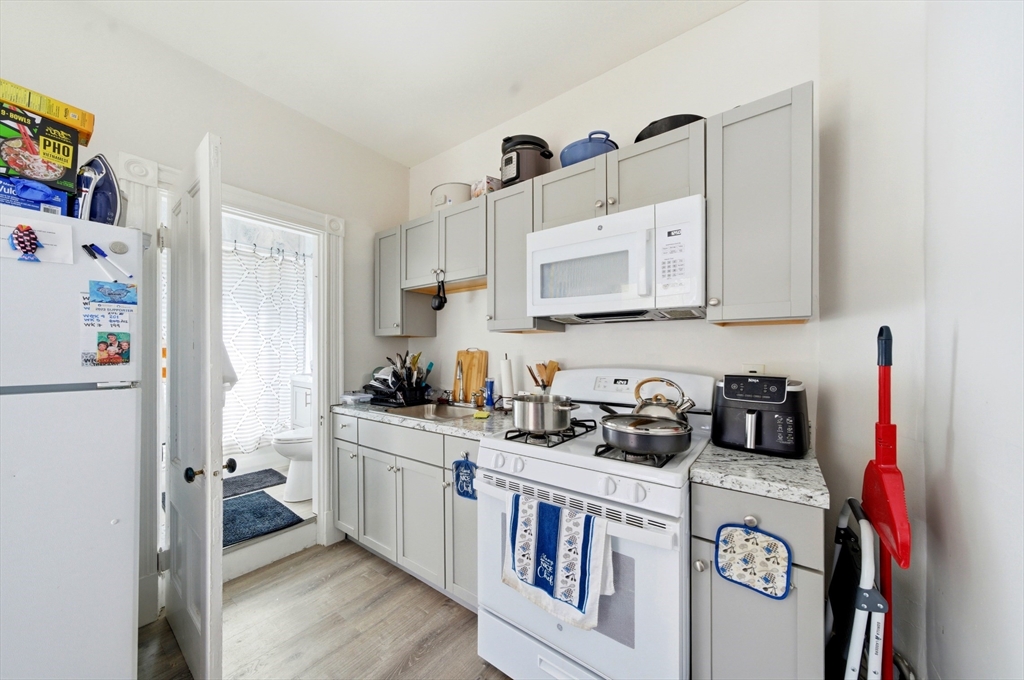 14-16 Ripley Street Malden, MA 02148 - Photo 31 of 37 a kitchen with stainless steel appliances granite countertop a refrigerator a stove a sink and dishwasher