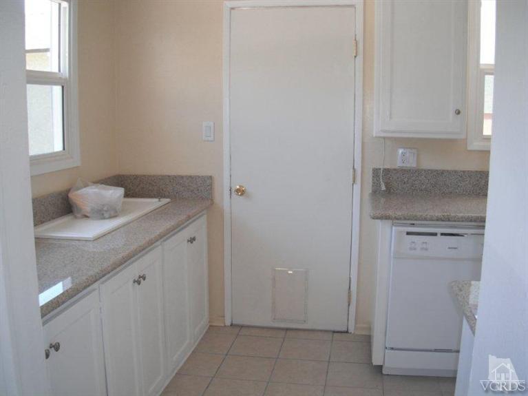 2117 Magnolia Street Simi Valley, CA 93065 - Photo 4 of 16 a bathroom with a granite countertop sink and cabinets