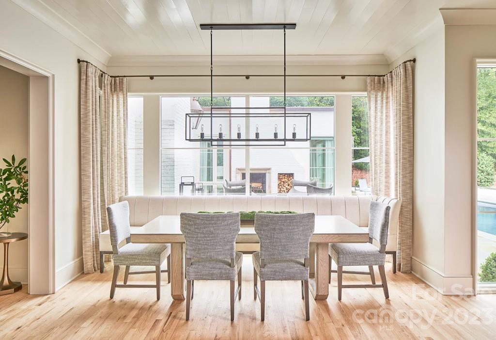 2527 Lemon Tree Lane Charlotte, NC 28211 - Photo 12 of 40 a dining room with furniture a chandelier and wooden floor