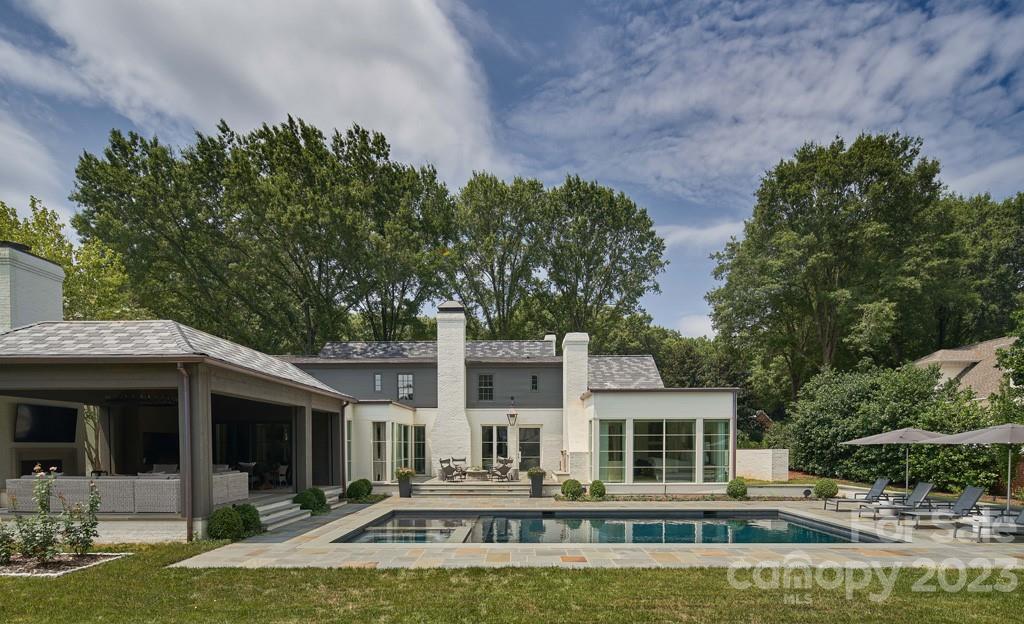 2527 Lemon Tree Lane Charlotte, NC 28211 - Photo 29 of 40 a front view of a house with swimming pool and porch with furniture