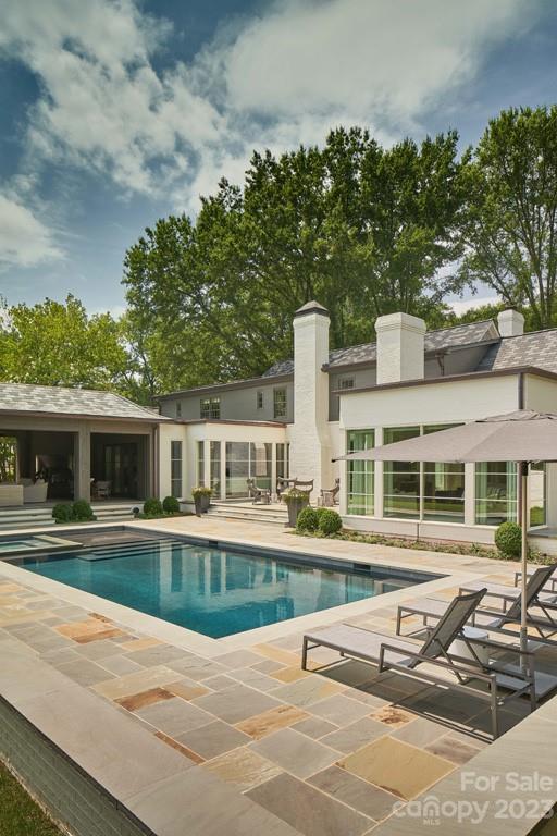 2527 Lemon Tree Lane Charlotte, NC 28211 - Photo 32 of 40 a view of a house with backyard sitting area and swimming pool