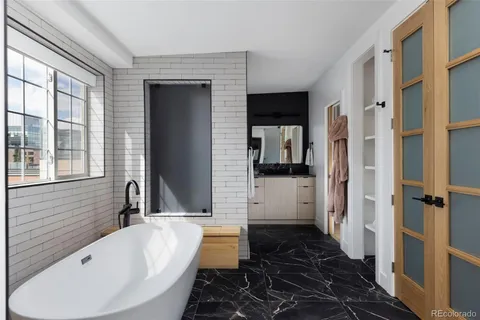 a bathroom with a bathtub and a shower