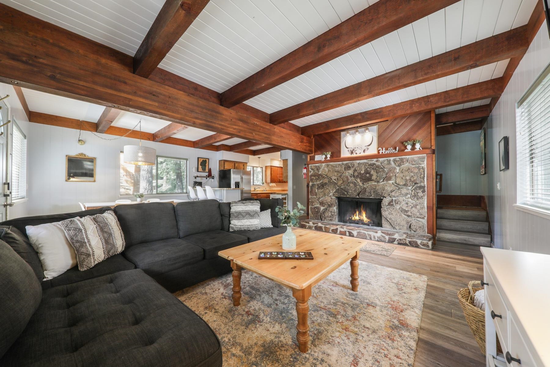 5656 Victoria Road Carnelian Bay, CA 96140 - Photo 11 of 28 a living room with furniture a fireplace and a table