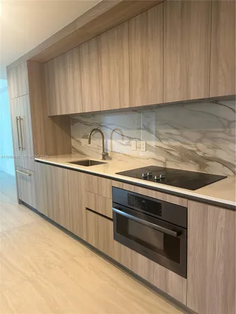 a kitchen with granite countertop cabinets stainless steel appliances and sink