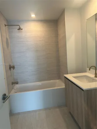 a bathroom with a bathtub and a sink