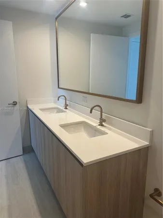 a bathroom with a double vanity sink and mirror