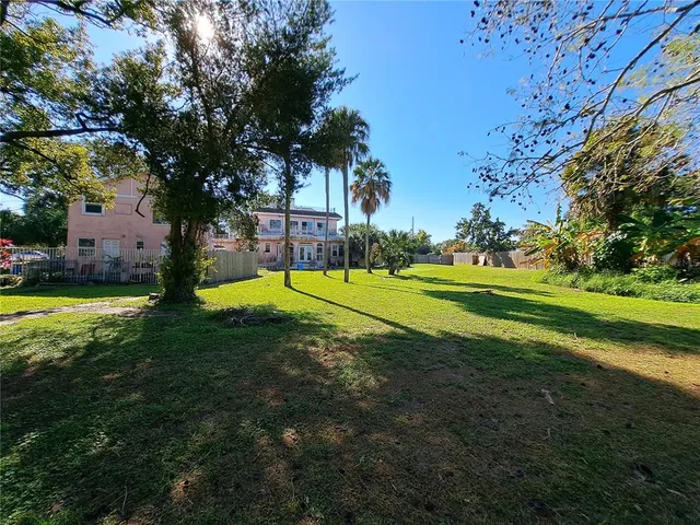 a view of a swimming pool with a garden and outdoor seating