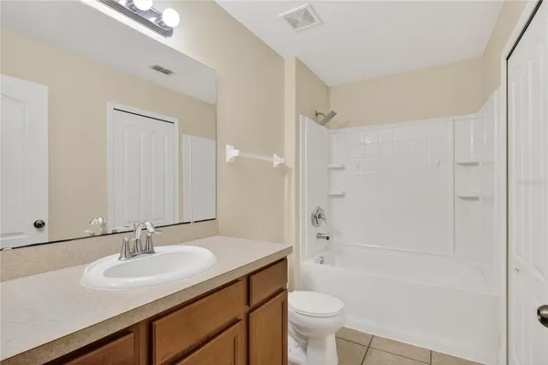 a bathroom with a sink toilet a mirror and shower