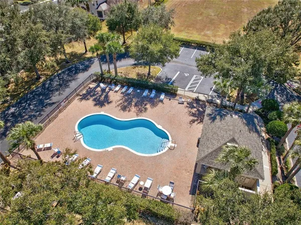 an aerial view of a house with a yard and lake view