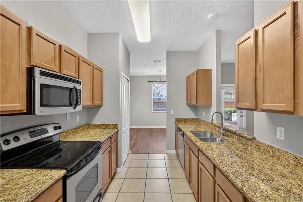 a kitchen with a stove microwave and sink