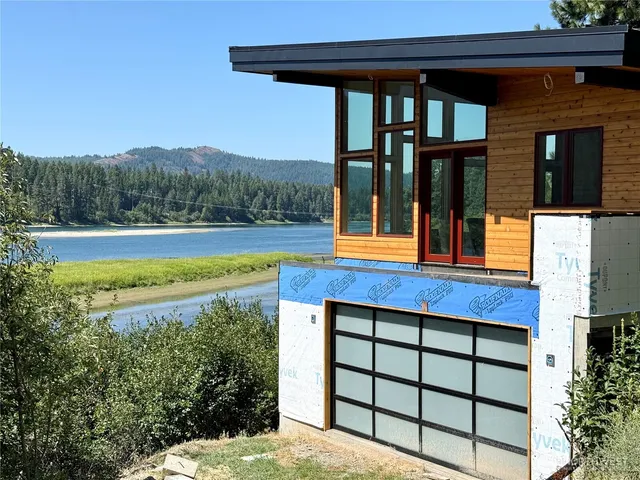 a view of a backyard with lake view and mountain view