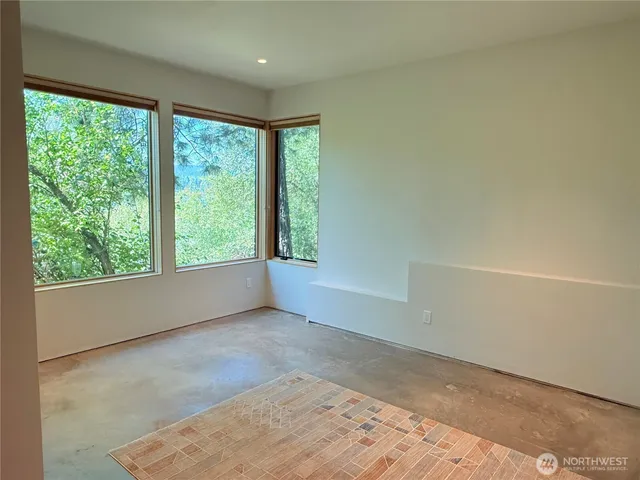 a view of a room with wooden floor