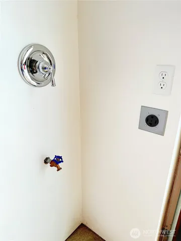 a view of a kitchen with a sink and large window