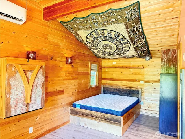 a view of a livingroom with wooden floor and a ceiling fan