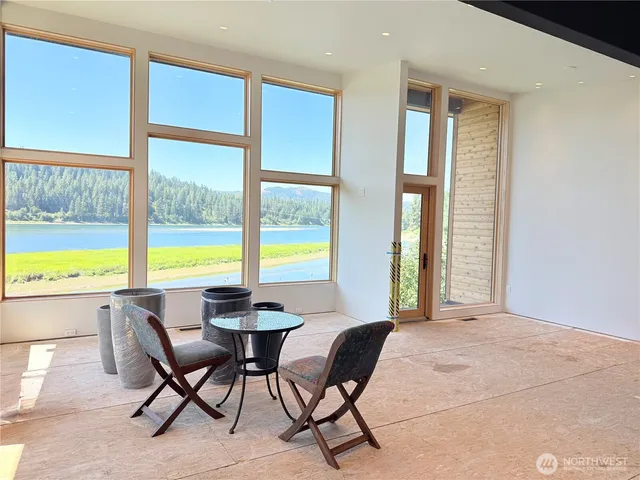 a view of a dining room with furniture and a large window