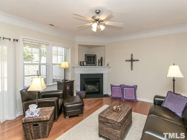 a living room with furniture a fireplace and a large window