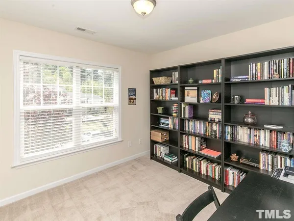 a bedroom with furniture and a book shelf