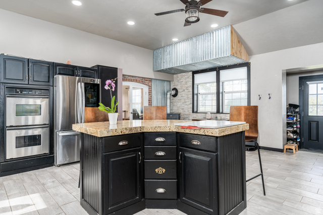 19994 South Olson Road Downey, ID 83234 - Photo 11 of 49 Kitchen featuring dark cabinets, a breakfast bar, a kitchen island, stainless steel appliances, and recessed lighting