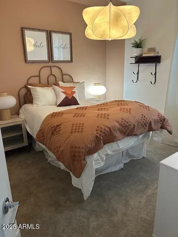 a bedroom with a bed and a chair