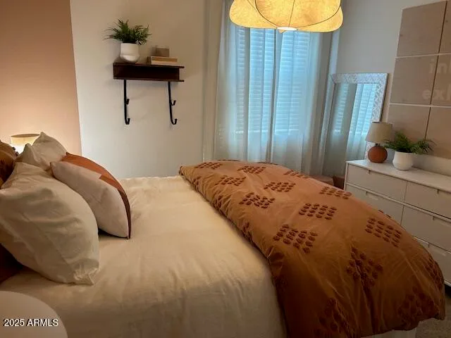 a bedroom with a bed and dresser