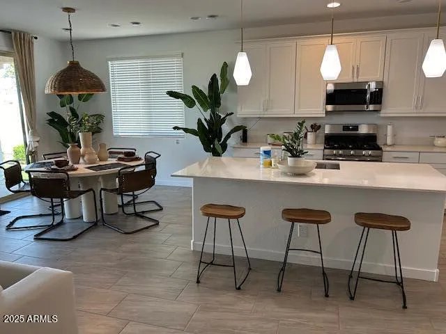a dining room with furniture and a chandelier