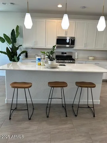 a view of kitchen with sink and breakfast area