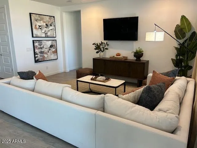 a living room with furniture and a flat screen tv