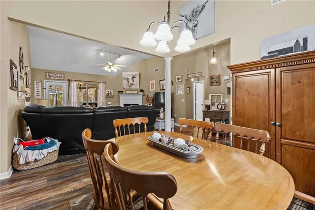 a view of a dining room with furniture and a chandelier