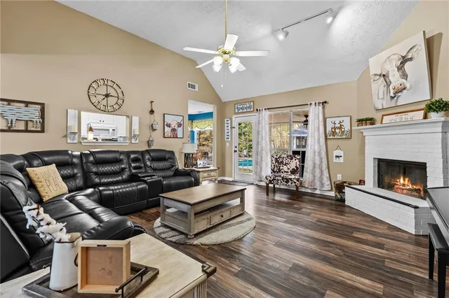 a living room with furniture a large window and fireplace