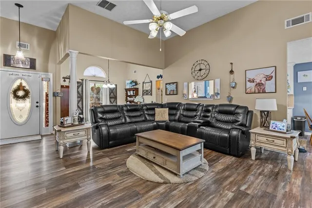 a living room with furniture and a wooden floor