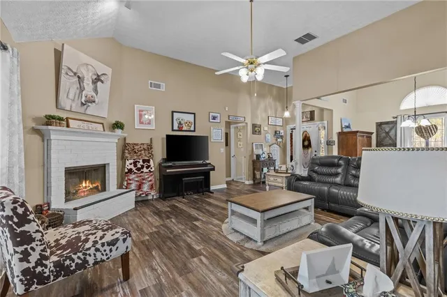 a living room with furniture a flat screen tv and a fireplace