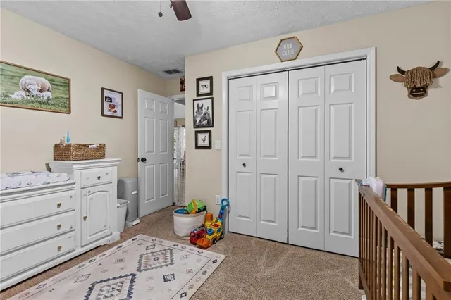 a view of a hallway with workspace and a window