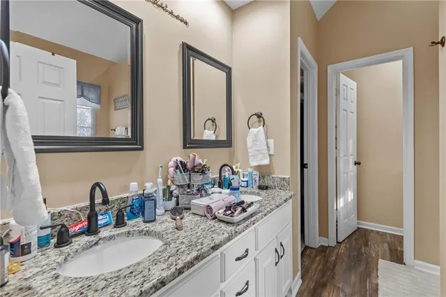 a bathroom with sink granite and a mirror
