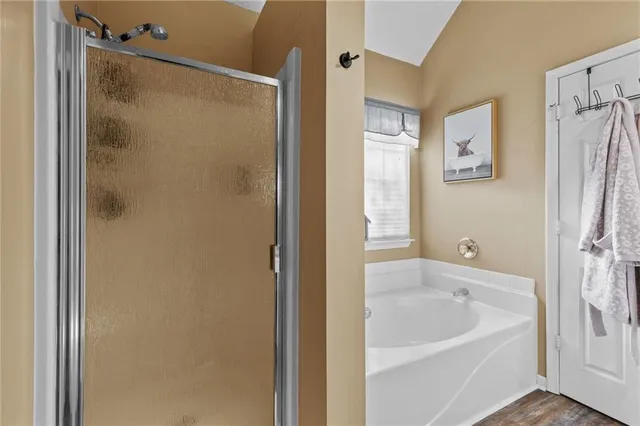 a white bath tub sitting next to a shower