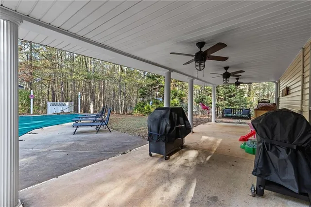 a view of a porch with furniture and a yard