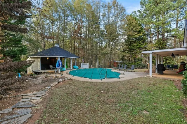 a view of a house with backyard and a tree