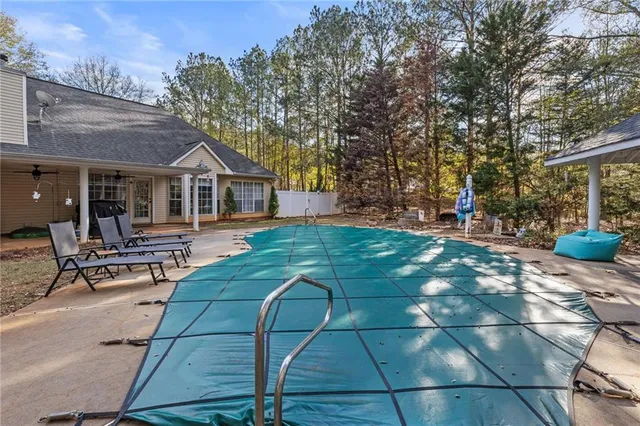 a view of a house with backyard porch and sitting area