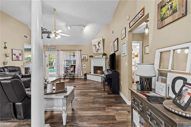 a living room with furniture a fireplace and a flat screen tv