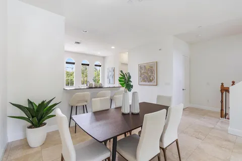 a view of a dining room with furniture and a potted plant