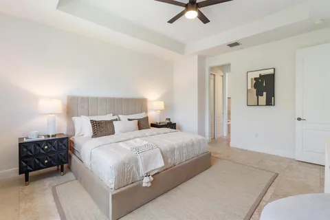 a bedroom with a bed a couch and a window