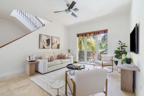 a living room with furniture a flat screen tv and a large window