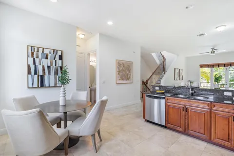 a dining hall with granite countertop a sink and chairs