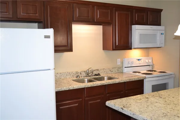 a kitchen with a sink a stove and refrigerator