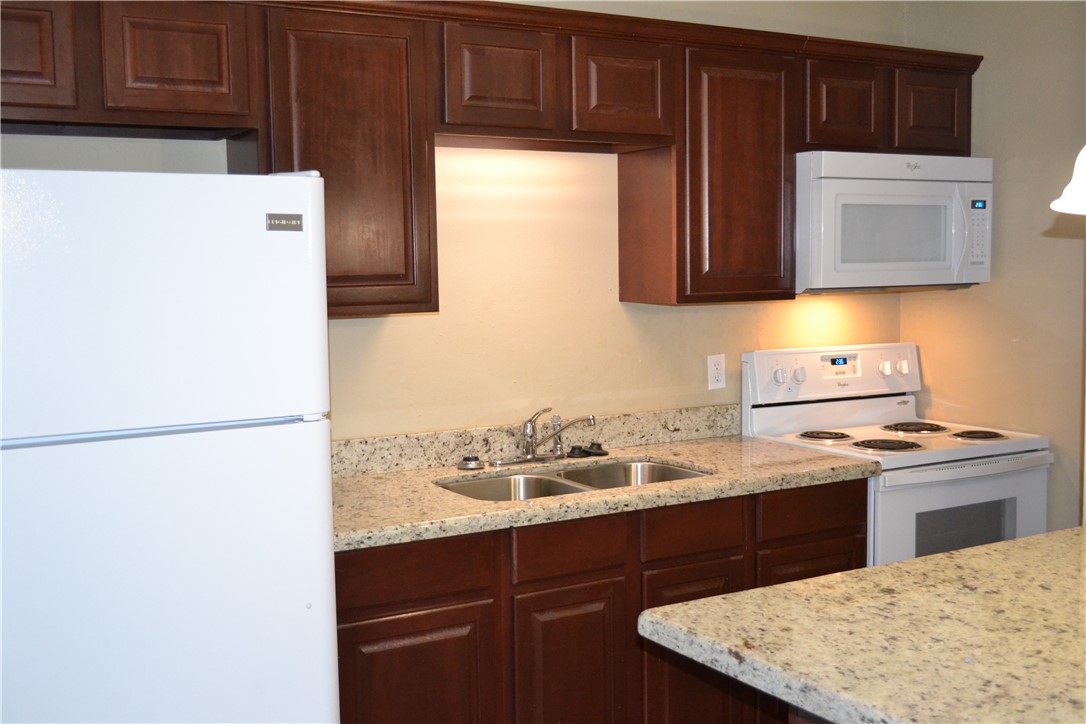 a kitchen with a sink a stove and refrigerator