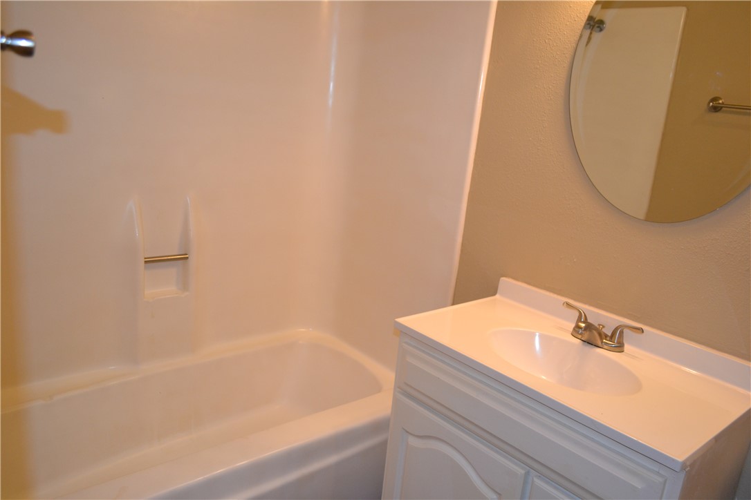 4212 Old College Road, Unit 7 Bryan, TX 77801 - Photo 14 of 19 a bathroom with a sink and a bathtub