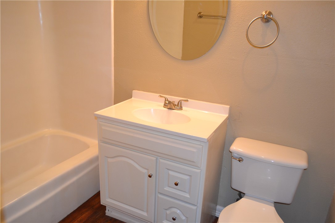 4212 Old College Road, Unit 7 Bryan, TX 77801 - Photo 15 of 19 a bathroom with a sink mirror vanity and toilet