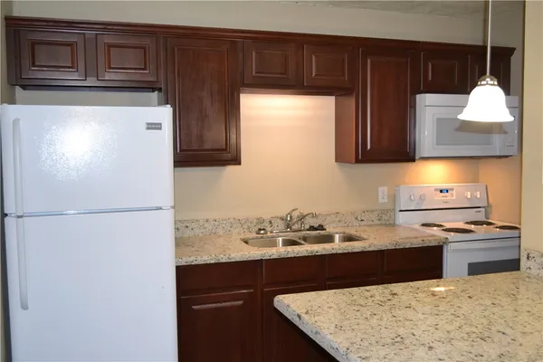 a kitchen with a sink a stove and refrigerator