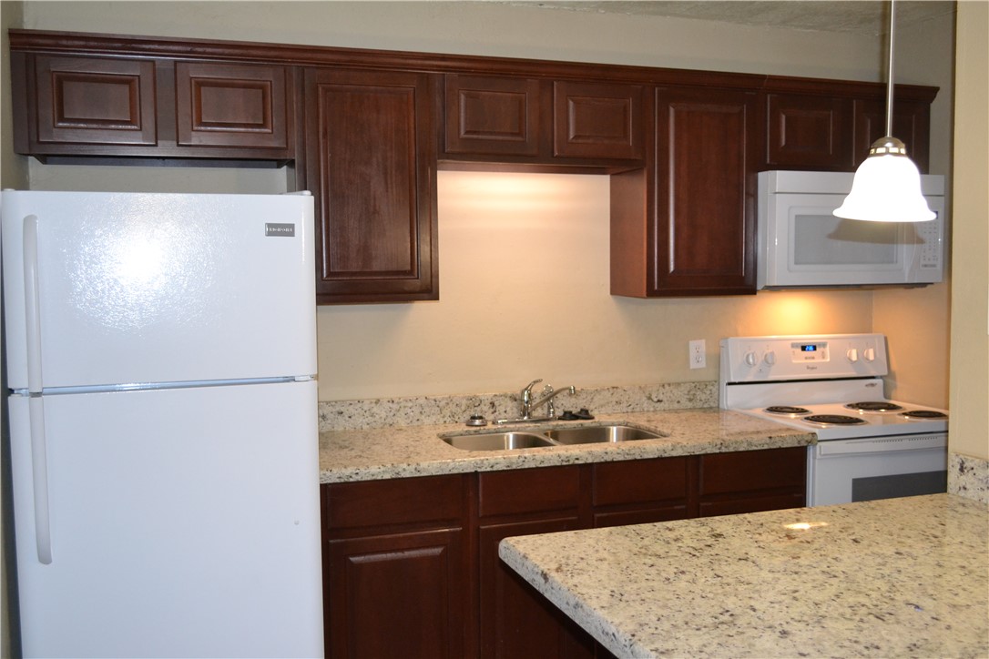 4212 Old College Road, Unit 7 Bryan, TX 77801 - Photo 2 of 19 a kitchen with a sink a stove and refrigerator